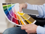 Man holding a set of paint color swatches in all the colors of the spectrum splayed out in his hand as he tries to decide on a new color for his house-066680-edited.jpeg Man holding a set of paint color swatches in all the colors of the spectrum splayed out in his hand as he tries to decide on a new color for his house-066680-edited.jpeg